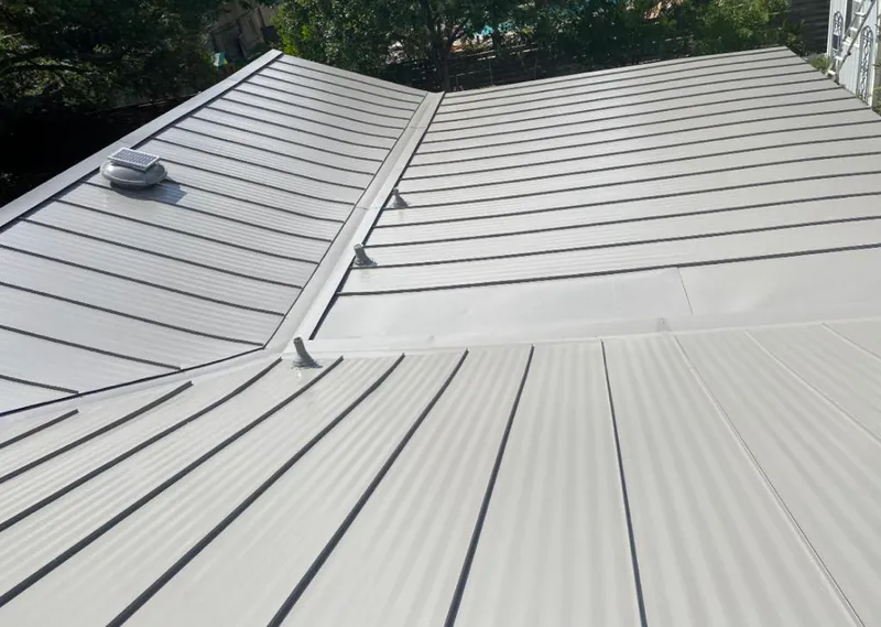 Solar attic fan installed on a metal roof for Roof Ventilation in Bloomington